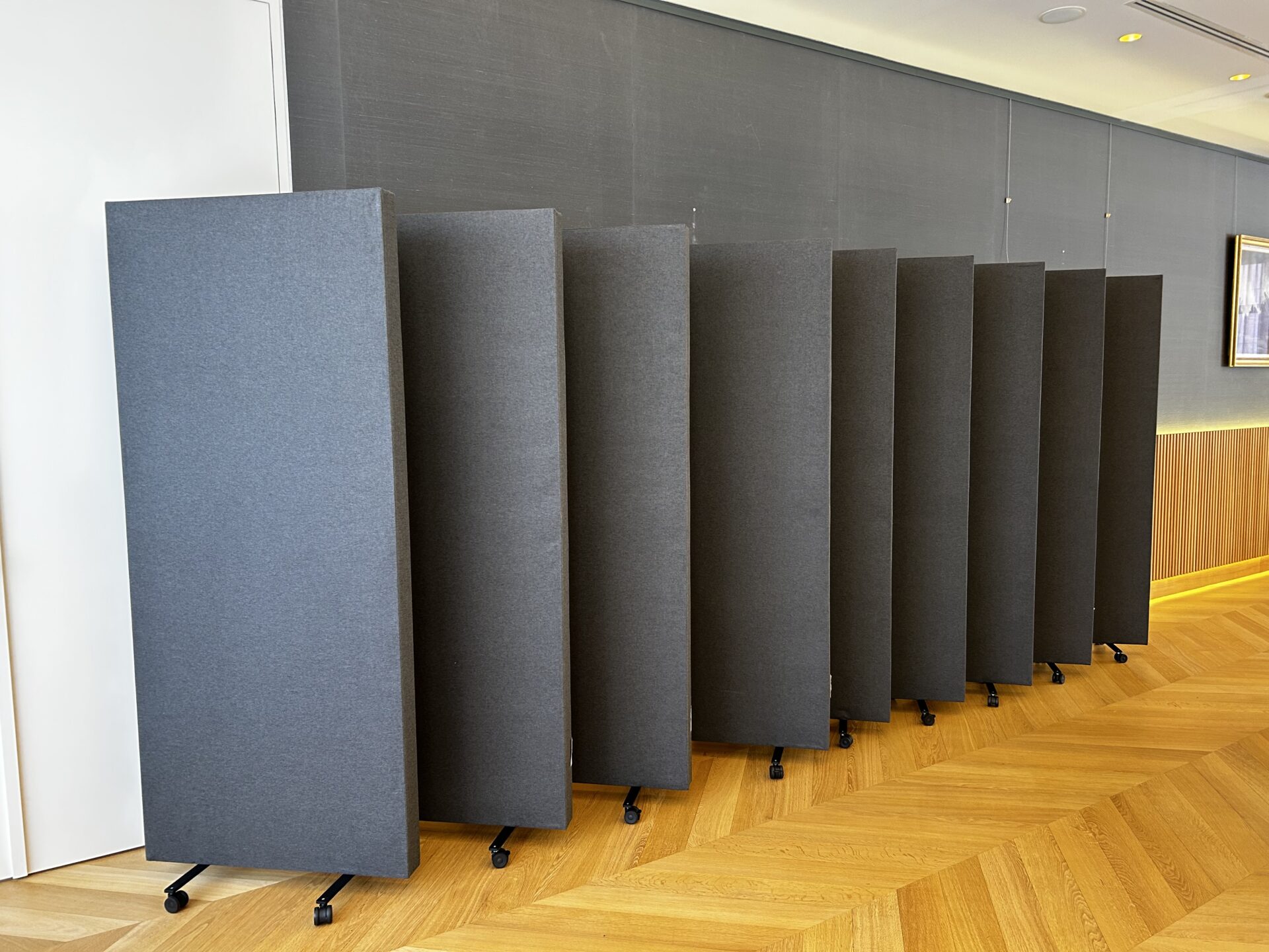 mobiele akoestische panelen op wieltjes in een kantoorruimte.